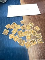 Group of orange-yellow 10¢ Washington stamps spread on table with envelope visible