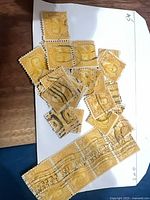 Pile of 10¢ yellow U.S. stamps showing quantity and cancellations