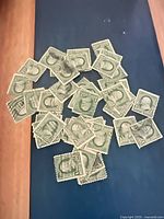 Spread of green 1¢ Franklin stamps on table