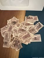 Pile of many identical 2c Landing of Columbus stamps on tabletop