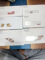 Five of the six envelopes with stamps visible through windows