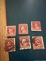 Six 12¢ claret brown U.S. stamps arranged on surface