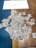 Pile of 3¢ Washington violet stamps on table