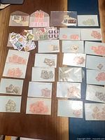 Overview of all glassine envelopes arranged on table containing Australian stamps