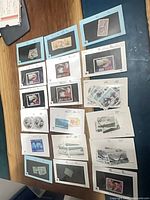 Overview of approximately 18 dealer cards each holding a single stamp