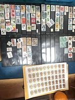 overview showing multiple album pages filled with Chinese stamps and full sheet of Russian stamps