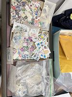 overview of trays with bags and envelopes of loose stamps