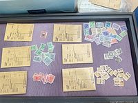 Overview of loose Austrian and Norwegian used stamps spread on purple background