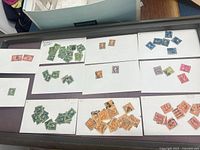 Tray with 11 cards each holding grouped used US stamps