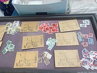 Top view of display case with multiple piles of stamps and several labeled envelopes