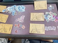 Overall view of assorted used stamps sorted by color on a tabletop