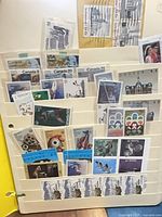 Album page showing multiple Canadian stamps (20¢ architecture, 10¢ wildlife, 43¢ landscapes, USA commemorative) in plastic pockets