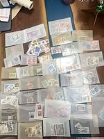 Overview of numerous glassine envelopes filled with used stamps spread on floor