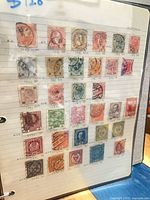 Album page with 30 Austrian cancelled stamps