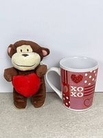 Monkey plush and mug side by side