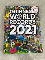 Front cover of Guinness World Records 2021 hardcover showing title and cover art