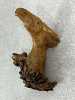 Full view of carved wood horse head sculpture