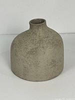 Front view of textured taupe-grey ceramic vase