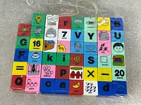 Front view of forty printed learning blocks in bag