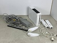 Overall view: console, two remotes, two nunchucks, sensor bar, power adapter, AV cable