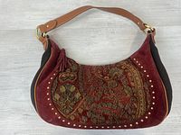 Front view of embroidered suede purse
