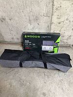 Boxed Woods Blaze two-burner camp stove and folded loveseat chair bag