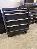 Front view of Husky 4-drawer tool chest showing drawers and Husky logo