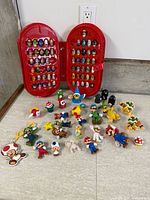 Full lot overview with open Mighty Beanz case and assorted Nintendo figures