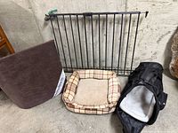 All four items: metal gate, dog pad, plaid bed, mesh carrier