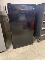Front view of black Hamilton Beach compact refrigerator