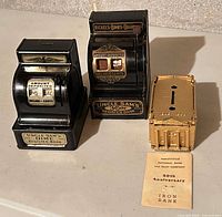 Front view showing two Uncle Sam’s register banks and Harleysville cast-iron bank with leaflet