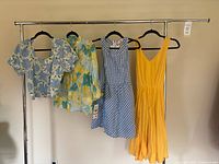 Overview of four clothing items on hangers