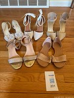 All five pairs of women’s shoes displayed on floor