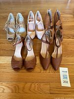 Group shot of all five shoe pairs on hardwood floor