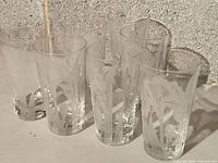 Group of seven matching etched glass tumblers