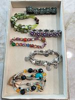 Tray view of all nine stretch bracelets arranged in rows