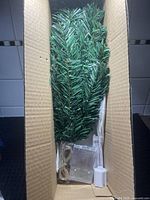 Boxed artificial Christmas tree components inside carton