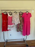 Full view of five garments on rack