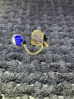 Close-up of two connected Saskatchewan teacher pins