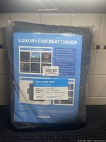 Front of packaged luxury car seat cover showing product information