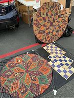 Two large round woven baskets and four checker placemats displayed