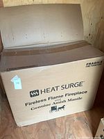 Sealed shipping box with Heat Surge Fireless Flame Fireplace and Genuine Amish Mantle branding