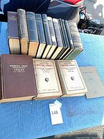 Full lot of fourteen books showing front covers and spines