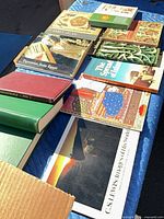Assortment of books laid out on blanket showing titles Early Islam, Treasures from Egypt, The Spread of Islam, Islamic art volume, C.S. Lewis volume and green hardcovers
