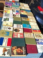 Overhead view of roughly four dozen books laid out, mix of paperbacks and hardcovers