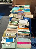 Overall lot view showing multiple rows of books and pamphlets on table