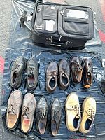Overview: suitcase and seven shoe pairs laid out