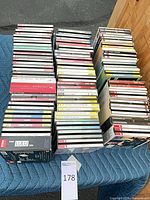 Three columns of stacked classical music CDs on moving blanket