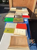 Table view of roughly 20 assorted books in various bindings