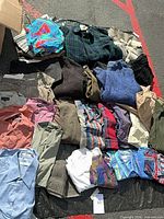 Overhead view of mixed shirts, sweaters and pants laid out